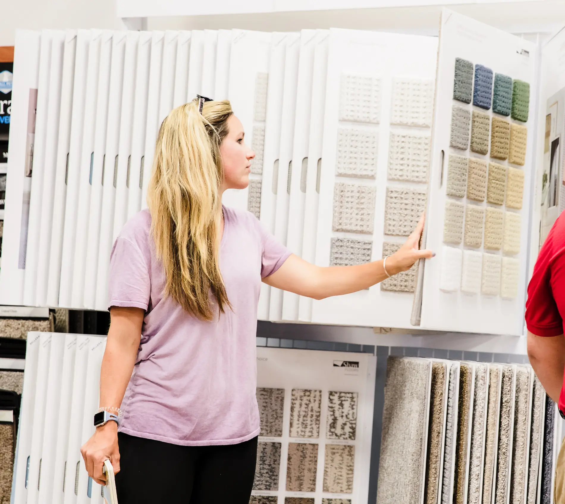 Women holding flooring sample in floor store 