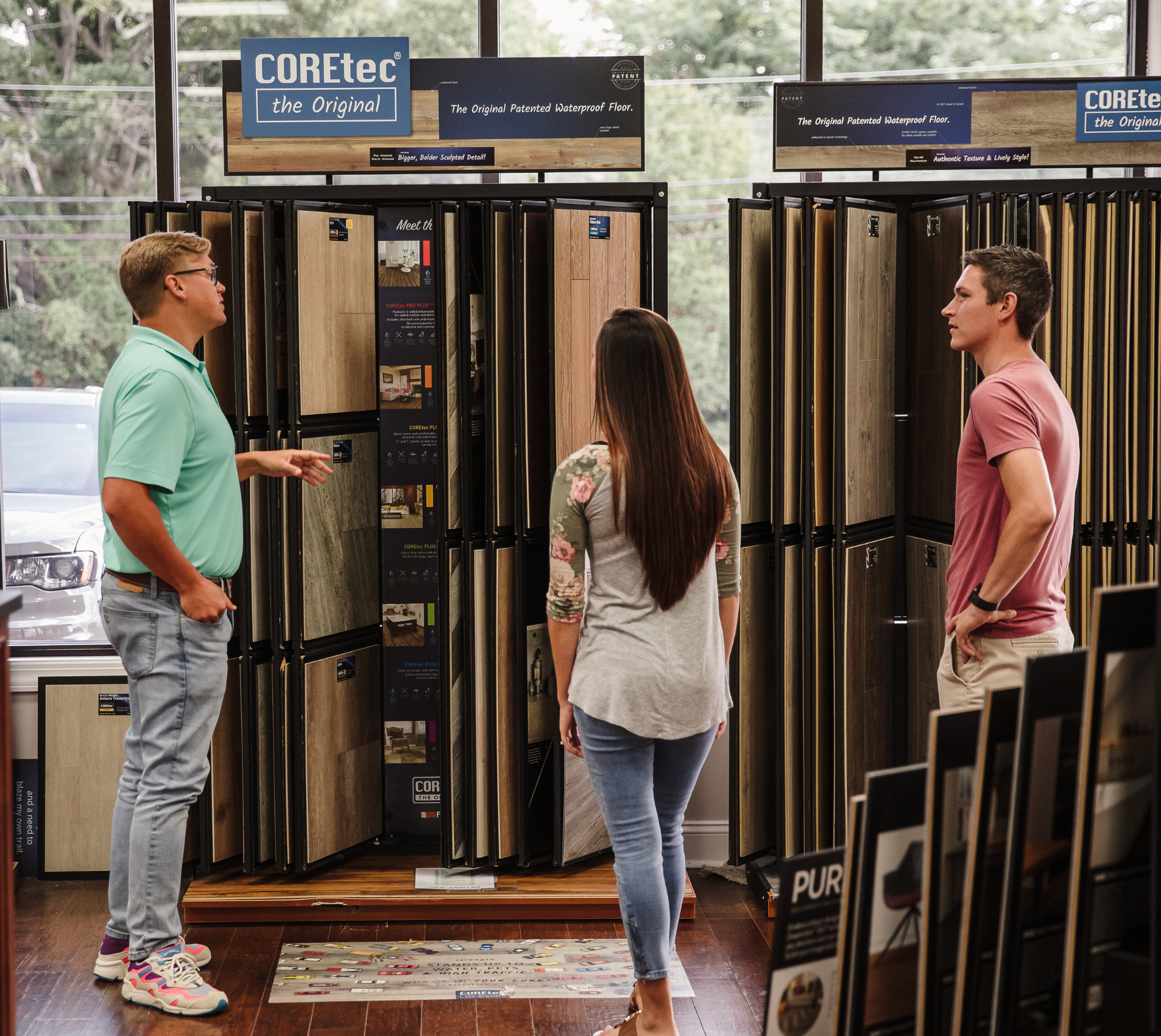 Couple Shopping for Flooring with Salesperson Helping 